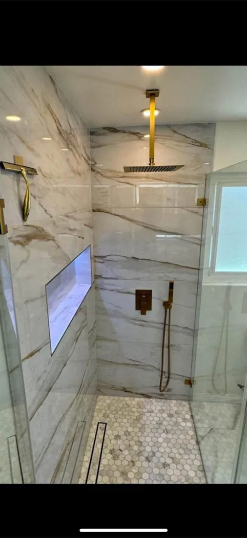 Custom marble tile shower with gold fixtures